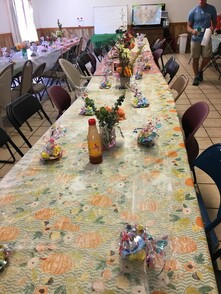 A photo of tables decorated with flowers and Easter treats.