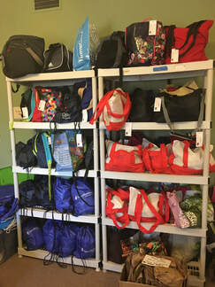 Photo of shelves filled with packed travel bags.